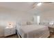 Bright and airy bedroom featuring white furniture, ceiling fan and light, and wood-look flooring at 5623 Midnight Pass Rd # 615, Sarasota, FL 34242