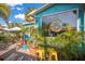 Exterior of Mojo Risin' Coffee Company, with its turquoise facade, tropical plants, and inviting outdoor seating at 5623 Midnight Pass Rd # 615, Sarasota, FL 34242