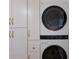New washer and dryer setup with custom built-in cabinetry and modern gold hardware at 5623 Midnight Pass Rd # 615, Sarasota, FL 34242