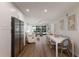 Bright living area with modern furniture, stainless steel refrigerator, and view to the outside patio space at 5623 Midnight Pass Rd # 615, Sarasota, FL 34242