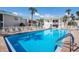 Community pool surrounded by lounge chairs and lush landscaping, offering a relaxing retreat at 5623 Midnight Pass Rd # 615, Sarasota, FL 34242
