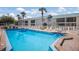 Resort style pool deck with lounge chairs surrounding the beautiful in-ground pool at 5623 Midnight Pass Rd # 615, Sarasota, FL 34242