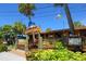 Cozy cottage-style restaurant with a wooden facade, tropical plants, and a welcoming entrance at 5623 Midnight Pass Rd # 615, Sarasota, FL 34242