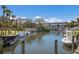 Scenic waterfront view with boats docked along a canal, showcasing the serene coastal living environment at 5623 Midnight Pass Rd # 615, Sarasota, FL 34242