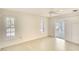 Bright and airy bedroom with light wood floors, plantation shutters, and access to patio at 5812 Garden Lakes Fern, Bradenton, FL 34203