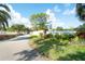 Community entrance featuring well-maintained landscaping, a decorative wall, and clear signage at 5812 Garden Lakes Fern, Bradenton, FL 34203