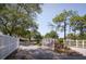 Elegant gated community entrance featuring a decorative white fence and lush landscaping at 5812 Garden Lakes Fern, Bradenton, FL 34203