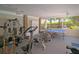 Spacious exercise room with gym equipment, brick accent wall, and views of the outdoors at 5812 Garden Lakes Fern, Bradenton, FL 34203
