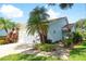 Charming single-story home with a well-manicured lawn, vibrant landscaping, and a two-car garage at 5812 Garden Lakes Fern, Bradenton, FL 34203