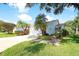 Charming home featuring a well-manicured lawn, mature palms, and a welcoming walkway at 5812 Garden Lakes Fern, Bradenton, FL 34203