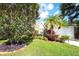 Charming home featuring lush landscaping, healthy green lawn, and a variety of plants and flowers at 5812 Garden Lakes Fern, Bradenton, FL 34203