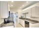 Bright, remodeled kitchen with white cabinets, granite countertops, and stainless steel appliances at 5812 Garden Lakes Fern, Bradenton, FL 34203