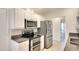 Modern kitchen with stainless steel appliances, granite countertops, and white cabinets at 5812 Garden Lakes Fern, Bradenton, FL 34203