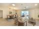 Open-concept living room and dining area with hardwood floors and lots of natural light at 5812 Garden Lakes Fern, Bradenton, FL 34203