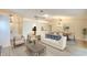 Bright living room flows into dining with modern furnishings and neutral color palette at 5812 Garden Lakes Fern, Bradenton, FL 34203