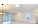 Bright living room with wood flooring, vaulted ceiling, and sliding glass doors to lanai at 5812 Garden Lakes Fern, Bradenton, FL 34203