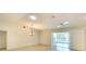 Bright living room with wood flooring, vaulted ceiling, and sliding glass doors to lanai at 5812 Garden Lakes Fern, Bradenton, FL 34203
