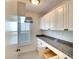 Bright pantry offers granite countertops, white cabinets and drawers, and natural light at 5812 Garden Lakes Fern, Bradenton, FL 34203