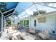 Spacious covered patio with outdoor dining, seating area, and landscaped backyard at 5812 Garden Lakes Fern, Bradenton, FL 34203