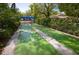 Outdoor shuffleboard court surrounded by tropical landscaping and trees at 5812 Garden Lakes Fern, Bradenton, FL 34203