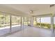 Bright sun room featuring lots of windows with views of the back yard and a ceiling fan at 5812 Garden Lakes Fern, Bradenton, FL 34203