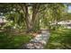 Scenic walking path lined with mature trees and lush greenery at 5812 Garden Lakes Fern, Bradenton, FL 34203