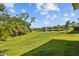 Expansive backyard featuring lush green grass and a serene pond view at 5816 Mezzana Run, Palmetto, FL 34221
