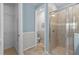 Bathroom showcasing tiled shower, patterned wall accents, and a separate toilet area at 5816 Mezzana Run, Palmetto, FL 34221