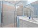 Bathroom featuring tiled shower with glass doors and a modern vanity with white countertop at 5816 Mezzana Run, Palmetto, FL 34221