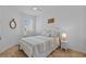 Bedroom featuring white walls, patterned bedding, and a ceiling fan at 5816 Mezzana Run, Palmetto, FL 34221