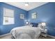 Comfortable bedroom with blue walls, ceiling fan, and bedside tables with lamps at 5816 Mezzana Run, Palmetto, FL 34221