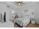 Comfortable bedroom with ceiling fan and adjacent bath at 5816 Mezzana Run, Palmetto, FL 34221