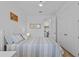Bright bedroom showcasing white walls, light-colored bedding, and a glimpse into the laundry area at 5816 Mezzana Run, Palmetto, FL 34221