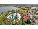 Overhead view featuring the community pool with mature trees, a clubhouse, and lush landscaping at 5816 Mezzana Run, Palmetto, FL 34221