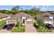 Charming single-Gathering home featuring a three-car garage and well-manicured landscaping at 5816 Mezzana Run, Palmetto, FL 34221