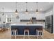 Modern kitchen features an island with seating, stainless steel appliances, and stylish pendant lighting at 5816 Mezzana Run, Palmetto, FL 34221