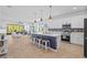 Open-concept kitchen with stainless appliances, center island, and seamless living area at 5816 Mezzana Run, Palmetto, FL 34221