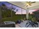 Relaxing screened lanai with serene views of the backyard, landscaping, and water at 5816 Mezzana Run, Palmetto, FL 34221