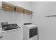 Laundry room with front load washer and dryer and shelving for storage at 5816 Mezzana Run, Palmetto, FL 34221