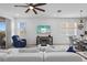 Comfortable living room with ceiling fan, television and slider access to the outside at 5816 Mezzana Run, Palmetto, FL 34221