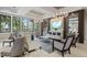 Well-lit living room with stylish seating arrangements and a large wall-mounted TV at 5816 Mezzana Run, Palmetto, FL 34221