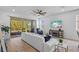 Bright living room with large sliding glass doors, ceiling fan and stylish furniture at 5816 Mezzana Run, Palmetto, FL 34221