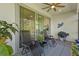 Cozy patio with comfortable seating, ceiling fan, grill, and sliding glass doors for indoor-outdoor living at 5816 Mezzana Run, Palmetto, FL 34221