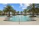 Beautiful community pool with inviting water, tiled edges, and tropical palm trees, perfect for relaxation at 5816 Mezzana Run, Palmetto, FL 34221