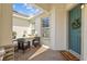 Inviting front porch seating area with a welcoming entrance and charming décor at 5816 Mezzana Run, Palmetto, FL 34221