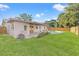 Expansive backyard showing pool, patio, grass, landscaping, and full view of home at 5900 6Th S Way, St Petersburg, FL 33705