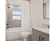Bathroom featuring a shower-tub combo with neutral tile surround and black matte fixtures at 5900 6Th S Way, St Petersburg, FL 33705