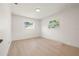 Bright bedroom featuring hardwood floors and natural light from the two windows at 5900 6Th S Way, St Petersburg, FL 33705