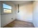 Bright bonus room with wood flooring, a window, and painted white shiplap walls at 5900 6Th S Way, St Petersburg, FL 33705