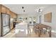 Modern kitchen with stainless steel appliances, a large island, and an adjacent dining area perfect for Gathering meals at 5900 6Th S Way, St Petersburg, FL 33705
